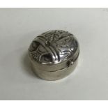 A small Continental silver pill box in the form of