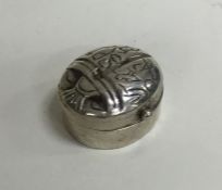 A small Continental silver pill box in the form of