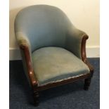 A mahogany upholstered armchair with sweeping hand