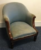 A mahogany upholstered armchair with sweeping hand