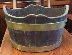 An oak and brass mounted peat bucket with shaped r