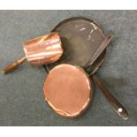 A copper and iron pan together with a coal shovel