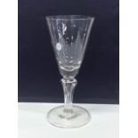 A large Georgian tapering drinking glass on fluted