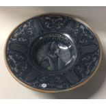 A stylish blue glazed pottery fruit bowl on pedest