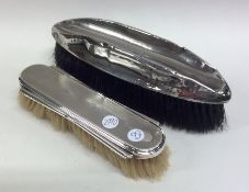 Two silver engine turned hairbrushes. Est. £20 - £