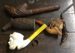 An old wooden carved pipe etc. Est. £20 - £30.