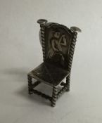 A small Continental silver model of a chair mounte