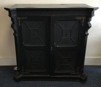 A large shaped front two door ebonised side cabine