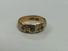An 18 carat gold sapphire and diamond ring. Approx