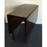 A mahogany drop leaf table of plain form. Est. £20