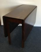 A mahogany drop leaf table of plain form. Est. £20