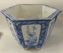 A Chinese blue and white hexagonal planter on pede