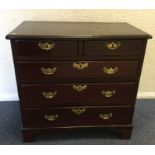 A Georgian chest of five drawers on bracket feet w