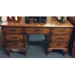 A mahogany and walnut nine drawer desk. Est. £80 -