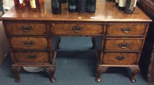 A mahogany and walnut nine drawer desk. Est. £80 -