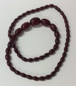 A red amber tapering necklace with barrel clasp. A