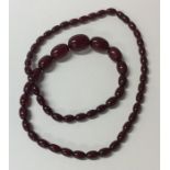 A red amber tapering necklace with barrel clasp. A