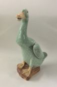 A Chinese celadon figure of a goose with textured