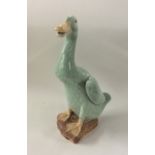 A Chinese celadon figure of a goose with textured