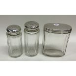 A group of three silver topped glass scent bottles