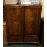 A Georgian mahogany two drawer cupboard. Est. £30