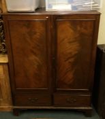 A Georgian mahogany two drawer cupboard. Est. £30
