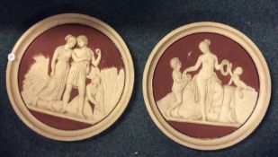 A pair of large circular terracotta plaques in rel