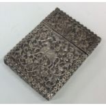 A heavy Indian silver card case decorated with ani
