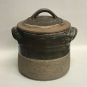 A partially glazed stoneware pottery cannister / l