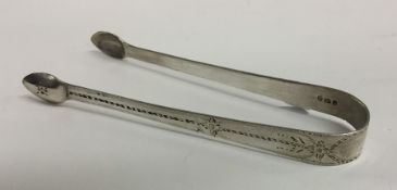 A pair of George III silver sugar tongs with brigh