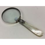 A large silver and MOP magnifier of tapering form.
