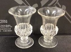 A pair of glass campana shaped vases on sweeping b