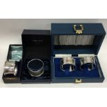 Three boxes containing silver napkin rings. Variou