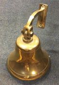 An old wall mounted ship's bell. Est. £20 - £30.