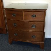 A bow front chest of four drawers on bracket feet