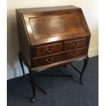 An Edwardian mahogany three drawer bureau. Est. £2