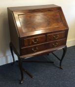 An Edwardian mahogany three drawer bureau. Est. £2