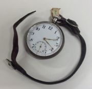 A silver open faced pocket watch with leather stra