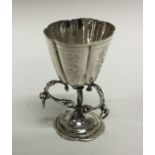 A silver table toy in the form of a cup with flute