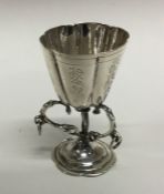 A silver table toy in the form of a cup with flute