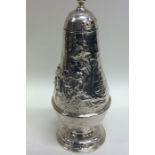 An unusual Victorian embossed silver sugar caster