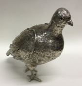 A large silver figure of a grouse with detachable