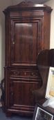 A large flame mahogany corner cupboard with single