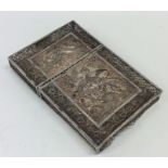 A heavy silver filigree card case decorated with b