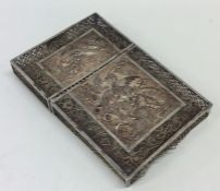 A heavy silver filigree card case decorated with b