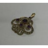 A stylish amethyst and pearl pendant with loop top