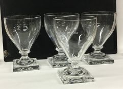 A set of four Georgian style wine glasses on squar
