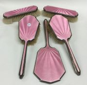 A five piece silver and pink enamelled dressing ta