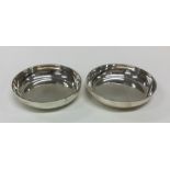 A pair of heavy silver tealight holders. London. B