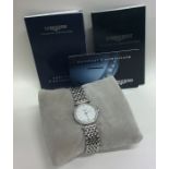 LONGINES: A lady's diamond mounted and stainless s